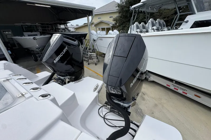 Slide: The Image of 2024 Caymas 34 CT boat with dual Mercury outboard engines in a marina setting. - 42