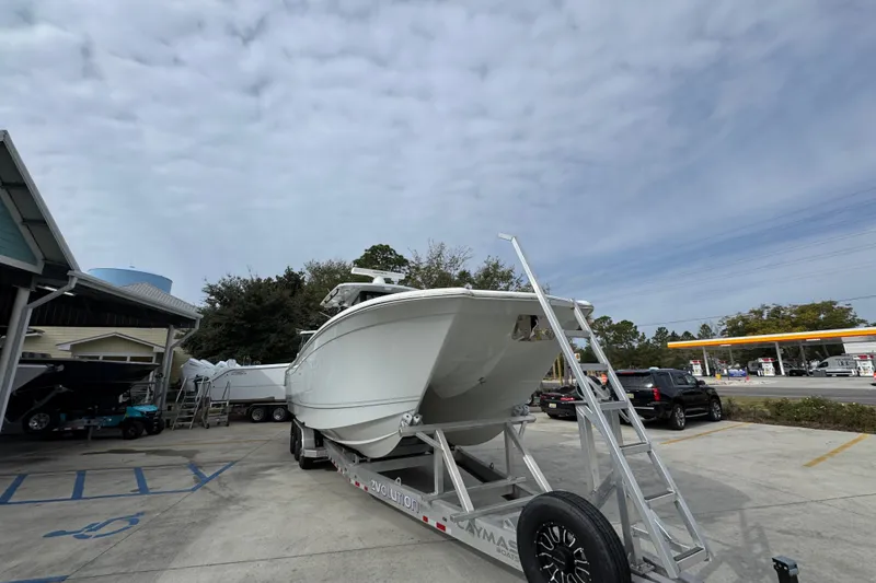Slide: The Image of 2024 Caymas 34 CT boat on trailer in parking lot under cloudy sky. - 7
