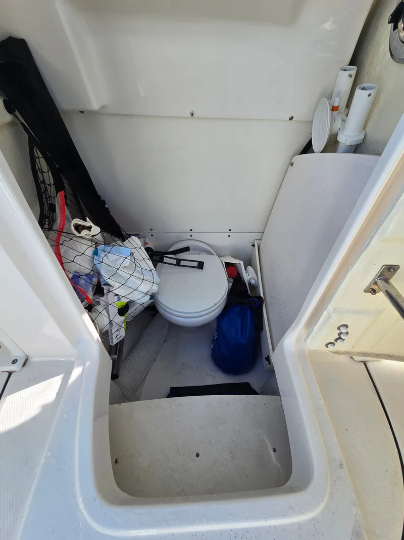 Slide: The Image of Interior of 2022 Robalo R272 Center Console with storage and toilet. - 15