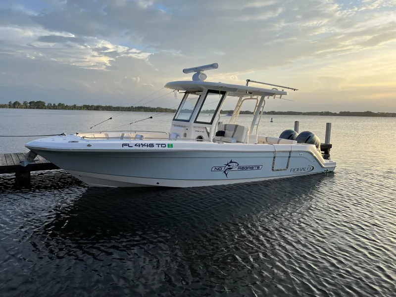 Slide: The Image of 2022 Robalo R272 Center Console boat docked at sunset. - 2