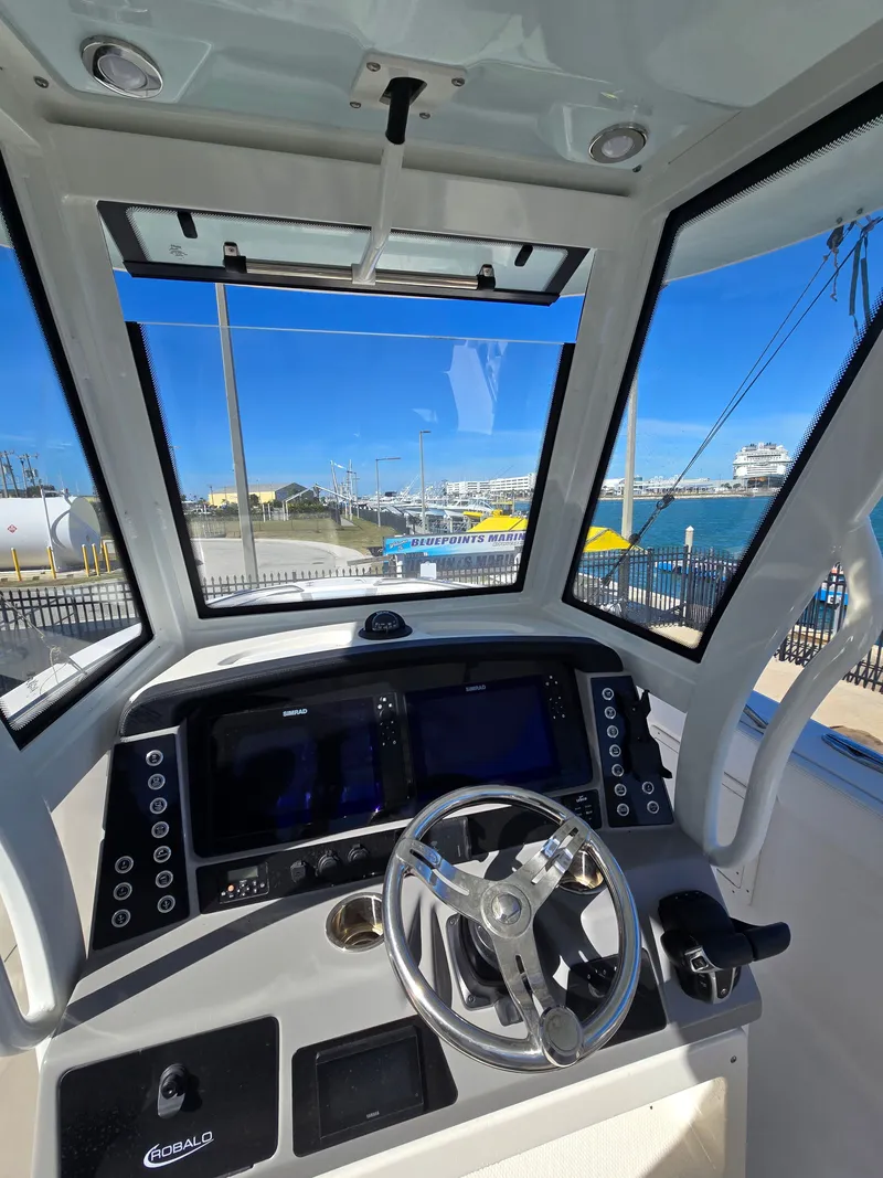 Slide: The Image of Interior view of 2022 Robalo R272 helm with ocean view. - 23