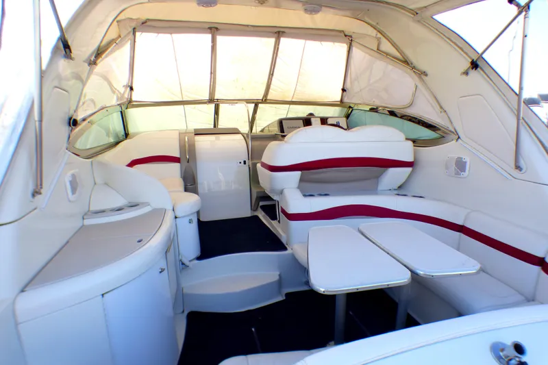 Slide: The Image of 2003 Formula 37 PC yacht interior with white and red seating, dining area, and helm. - 10