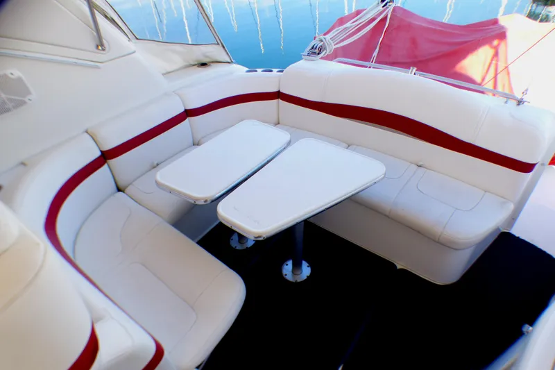 Slide: The Image of 2003 Formula 37 PC boat interior with white and red seating and dual tables. - 11