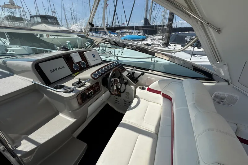 Slide: The Image of 2003 Formula 37 Performance Cruiser cockpit with Garmin navigation, white seating, and marina view. - 16