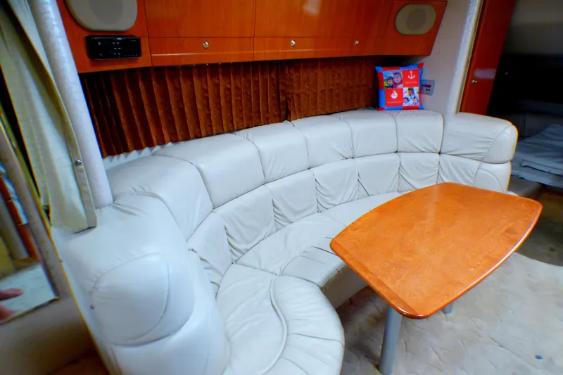 Slide: The Image of Luxurious interior of 2003 Formula 37 PC yacht with curved leather seating and wooden table. - 23