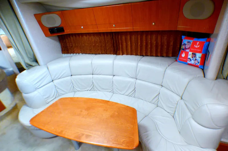 Slide: The Image of 2003 Formula 37 PC yacht interior with curved leather seating and wooden table. - 24