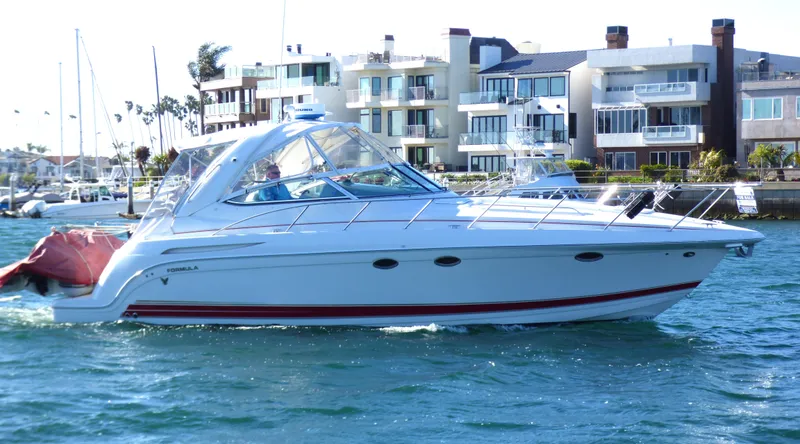 Slide: The Image of 2003 Formula 37 PC yacht cruising near waterfront homes. - 3