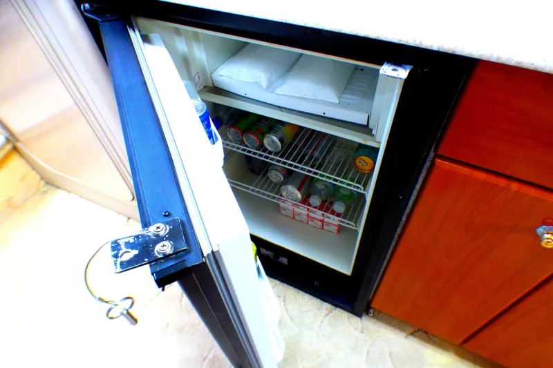 Slide: The Image of Mini fridge in 2003 Formula 37 PC yacht, stocked with beverages and ice packs. - 30