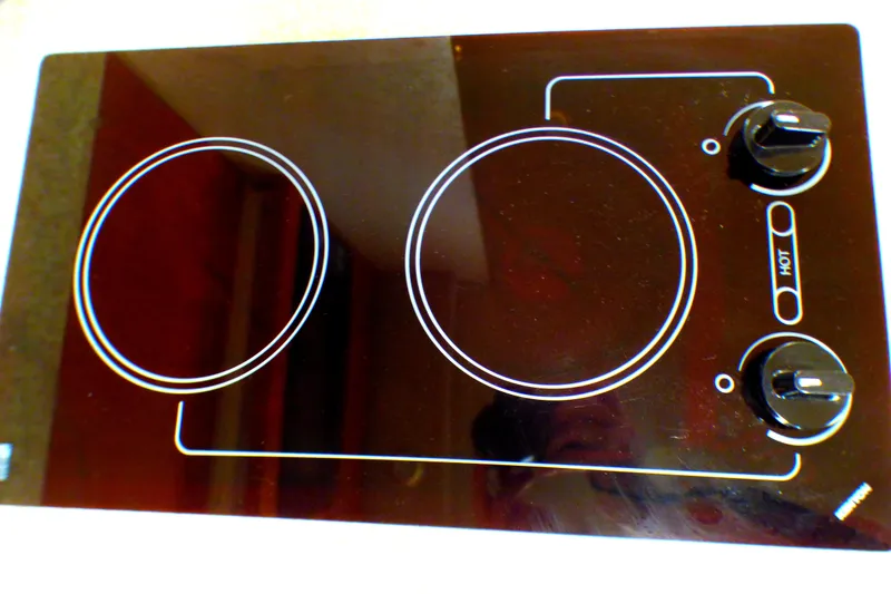 Slide: The Image of Ceramic cooktop with two burners and control knobs, part of a 2003 Formula 37 PC. - 32