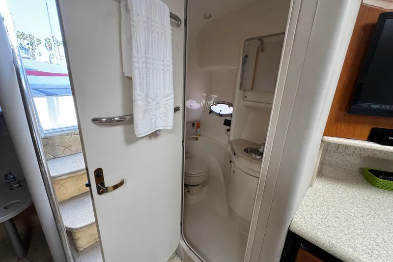 Slide: The Image of Interior of 2003 Formula 37 Performance Cruiser bathroom with compact design and amenities. - 35