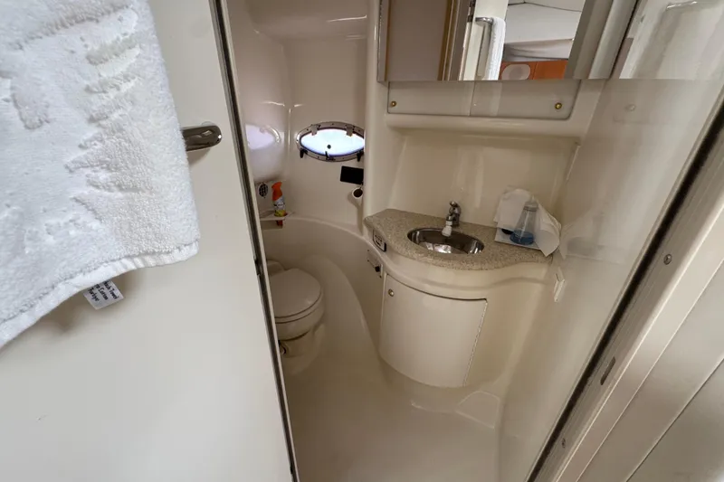 Slide: The Image of 2003 Formula 37 Performance Cruiser bathroom with sink, toilet, and porthole window. - 36