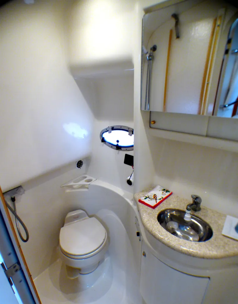 Slide: The Image of 2003 Formula 37 PC yacht bathroom with toilet, sink, and mirror. - 38