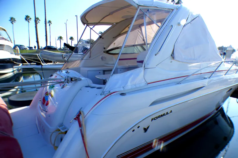 Slide: The Image of 2003 Formula 37 PC yacht docked at marina, featuring sleek design and white exterior. - 4