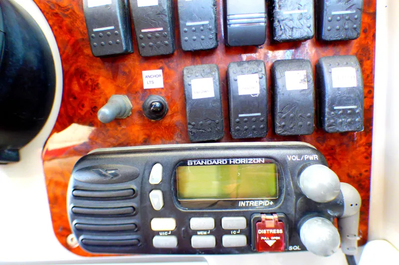 Slide: The Image of Control panel of a 2003 Formula 37 PC boat with radio and switches. - 45
