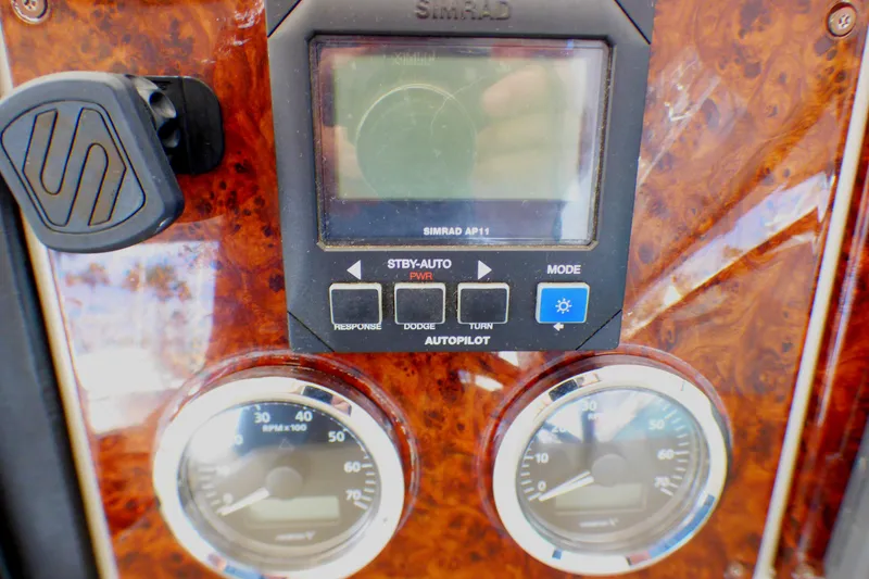 Slide: The Image of Control panel of a 2003 Formula 37 PC boat with gauges and autopilot system. - 46