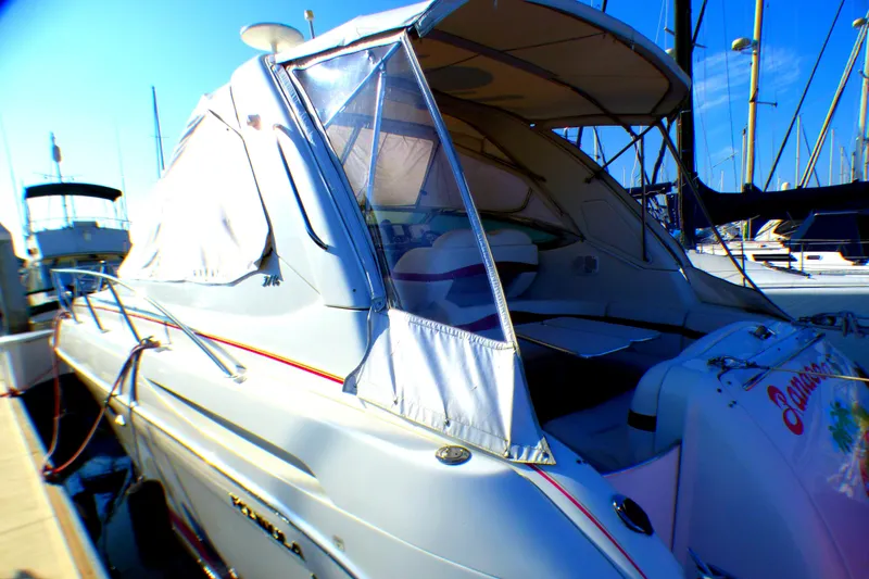 Slide: The Image of 2003 Formula 37 PC yacht docked at marina with covered cockpit and clear blue sky. - 5