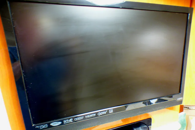 Slide: The Image of Flat-screen TV mounted on a wooden wall inside a 2003 Formula 37 PC boat. - 51