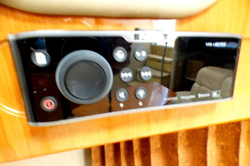 Slide: The Image of Control panel of a 2003 Formula 37 PC boat with various buttons and a dial. - 53