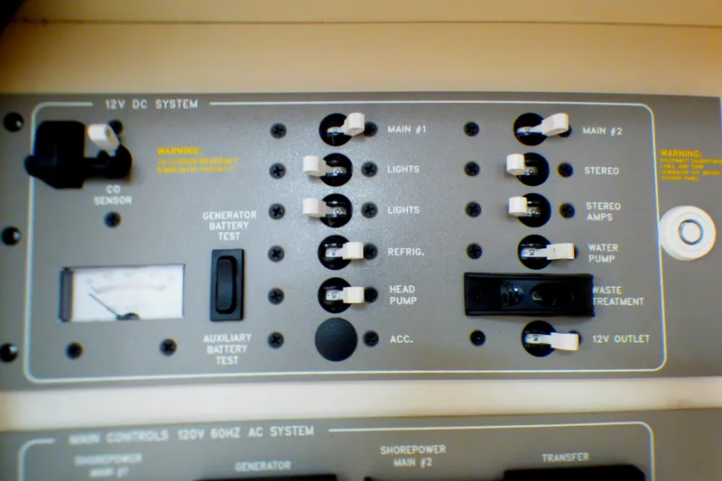 Slide: The Image of Control panel of a 2003 Formula 37 PC boat, featuring various switches and gauges. - 55