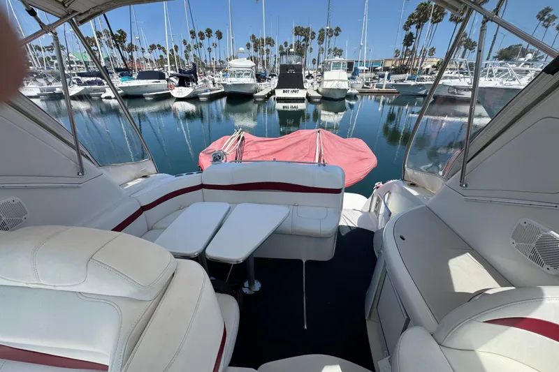 Slide: The Image of 2003 Formula 37 Performance Cruiser interior with marina view, featuring white seating and table. - 58