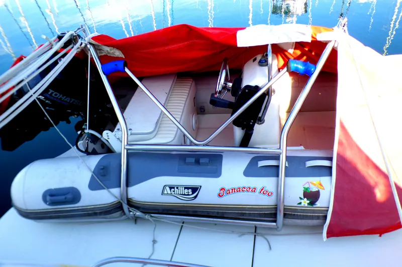 Slide: The Image of 2003 Formula 37 PC boat with red cover and inflatable dinghy on deck. - 62