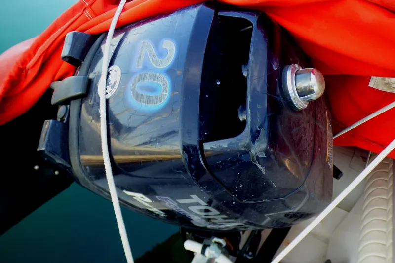 Slide: The Image of Outboard motor on a 2003 Formula 37 PC boat, covered with an orange tarp. - 63