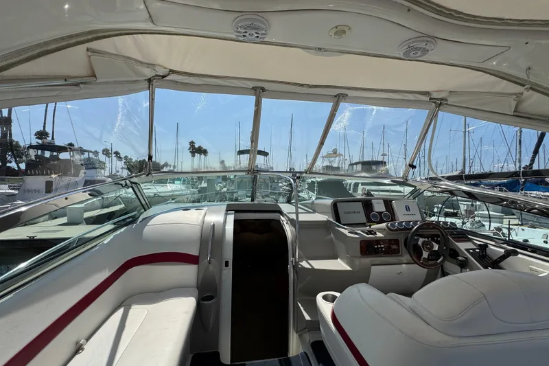 Slide: The Image of 2003 Formula 37 Performance Cruiser cockpit with marina view, featuring navigation equipment and seating. - 9
