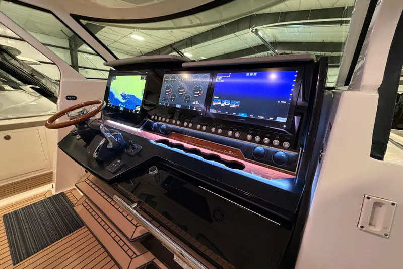 Slide: The Image of 2024 Tiara Yachts 48 LS helm with advanced navigation displays and controls. - 12
