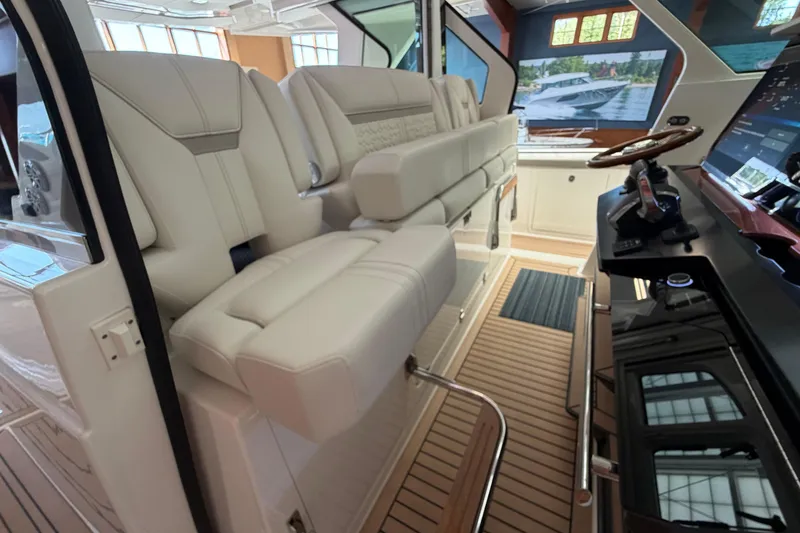 Slide: The Image of 2024 Tiara Yachts 48 LS interior with luxurious seating and modern helm controls. - 13