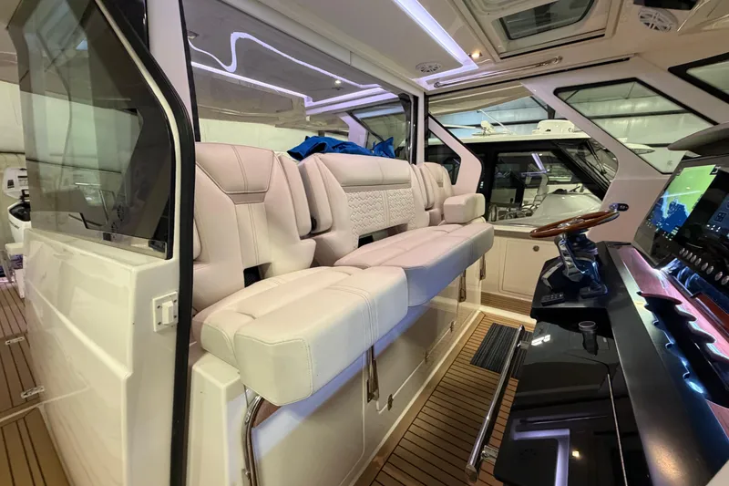 Slide: The Image of 2024 Tiara Yachts 48 LS interior with luxurious seating and modern helm controls. - 14