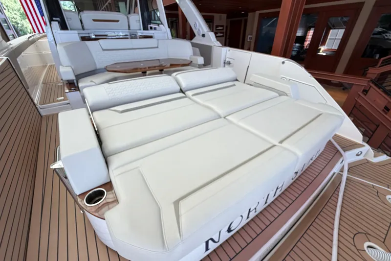 Slide: The Image of 2024 Tiara Yachts 48 LS luxury deck with plush seating and elegant wood finish. - 47