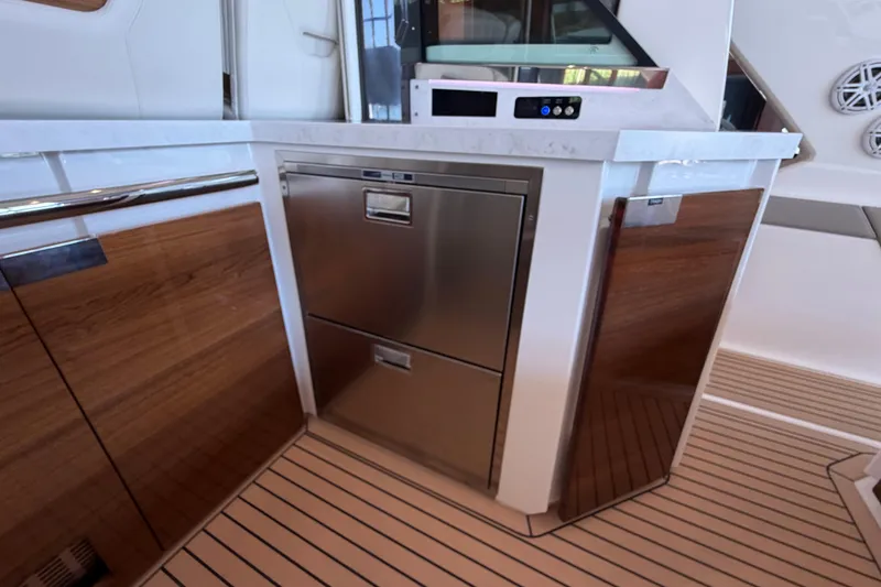 Slide: The Image of 2024 Tiara Yachts 48 LS interior with sleek cabinetry and modern appliances. - 35