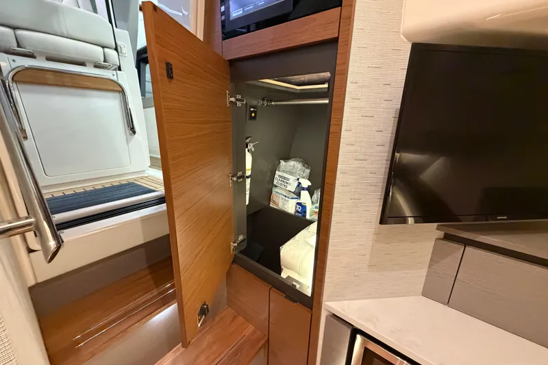 Slide: The Image of 2024 Tiara Yachts 48 LS interior storage with open cabinet and modern design. - 23