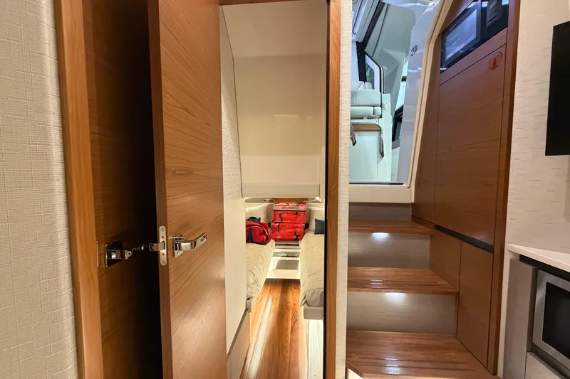 Slide: The Image of Interior of 2024 Tiara Yachts 48 LS, featuring wooden stairs and modern design elements. - 24