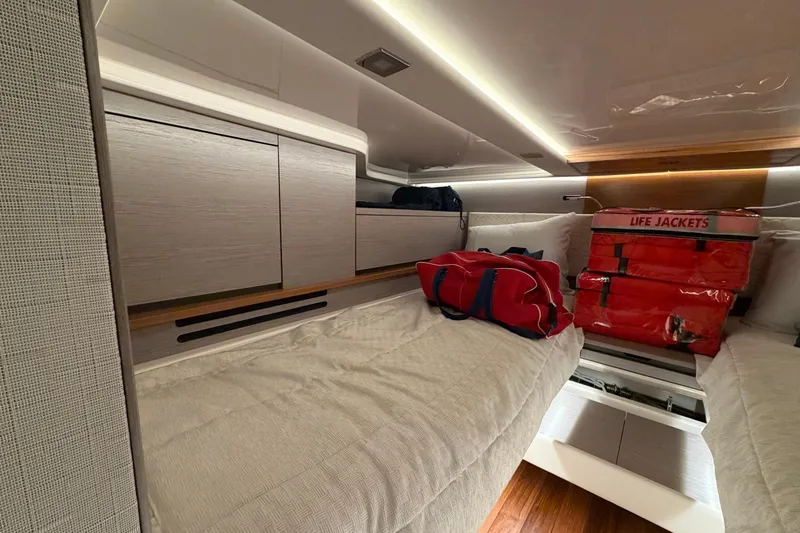 Slide: The Image of 2024 Tiara Yachts 48 LS interior cabin with life jackets and storage. - 26