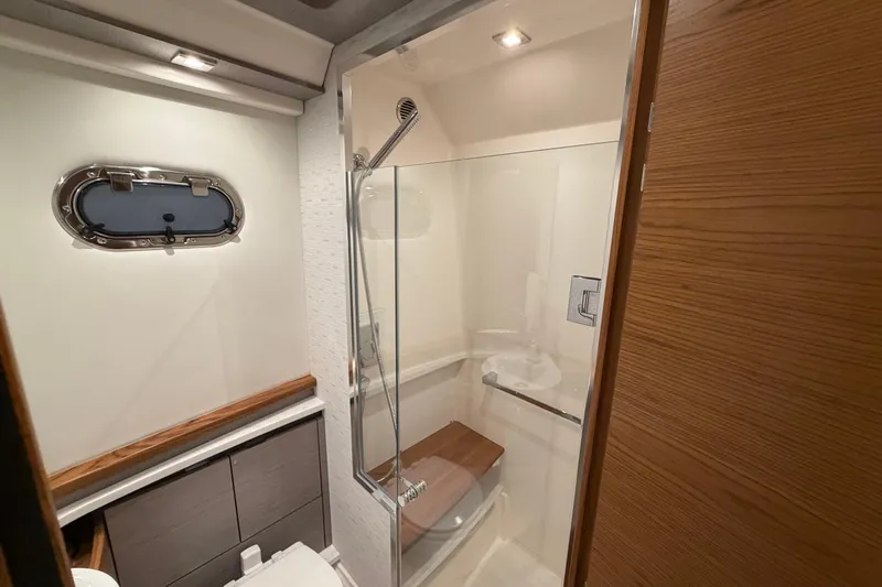 Slide: The Image of Luxurious bathroom in 2024 Tiara Yachts 48 LS, featuring modern shower and elegant wood accents. - 28