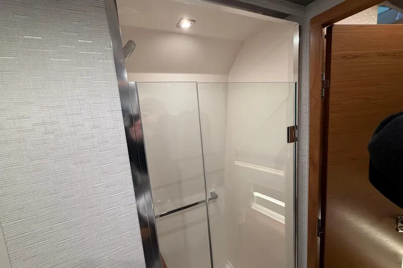 Slide: The Image of 2024 Tiara Yachts 48 LS interior shower with glass door and modern design. - 29