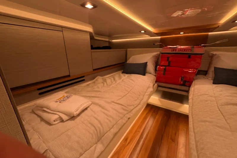 Slide: The Image of Luxurious cabin interior of 2024 Tiara Yachts 48 LS with cozy bedding and life jackets. - 29