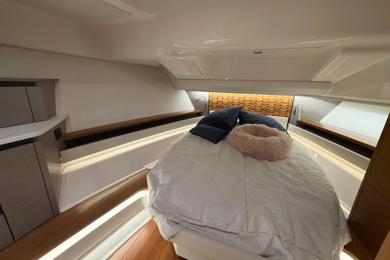 Slide: The Image of Luxurious cabin interior of 2024 Tiara Yachts 48 LS with cozy bedding and modern design. - 30
