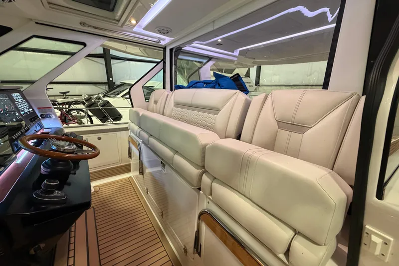 Slide: The Image of 2024 Tiara Yachts 48 LS interior with luxurious seating and modern helm controls. - 32