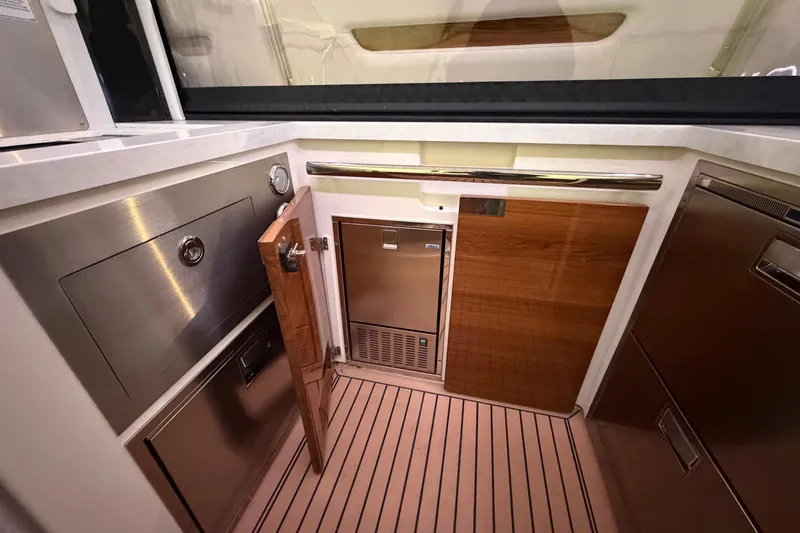 Slide: The Image of 2024 Tiara Yachts 48 LS interior with modern kitchen appliances and wood accents. - 37