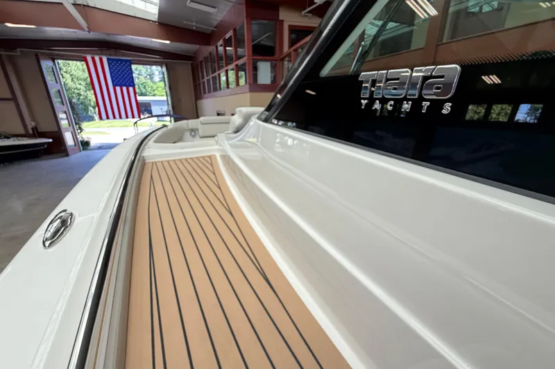 Slide: The Image of 2024 Tiara Yachts 48 LS in showroom with American flag in background. - 31