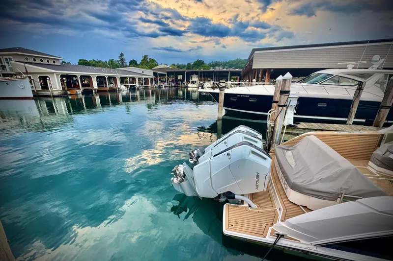 Slide: The Image of 2024 Tiara Yachts 48 LS docked at marina under cloudy sky. - 4