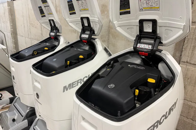 Slide: The Image of Three Mercury outboard engines on a 2024 Tiara Yachts 48 LS, with open covers. - 43