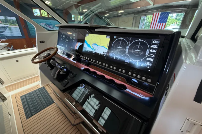 Slide: The Image of 2024 Tiara Yachts 48 LS helm with advanced navigation displays and controls. - 14