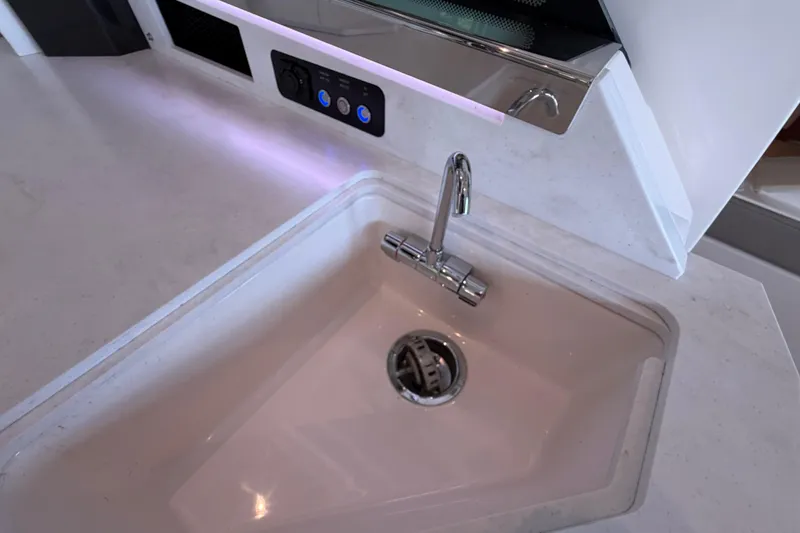 Slide: The Image of Modern sink and faucet on 2024 Tiara Yachts 48 LS, featuring sleek design and controls. - 40