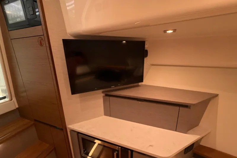 Slide: The Image of 2024 Tiara Yachts 48 LS interior with TV and modern cabinetry. - 22