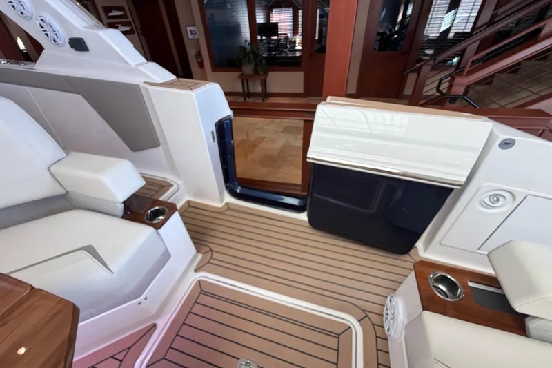 Slide: The Image of Luxurious interior of 2024 Tiara Yachts 48 LS with elegant seating and wood accents. - 45