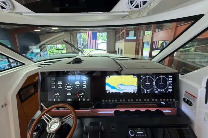 Slide: The Image of 2024 Tiara Yachts 48 LS helm with advanced navigation displays and controls. - 18
