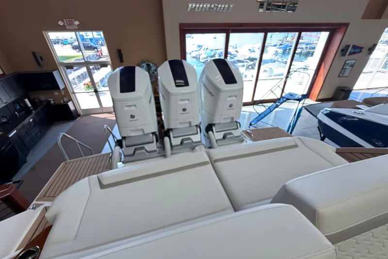 Slide: The Image of 2024 Tiara Yachts 48 LS with triple outboard engines in showroom. - 44